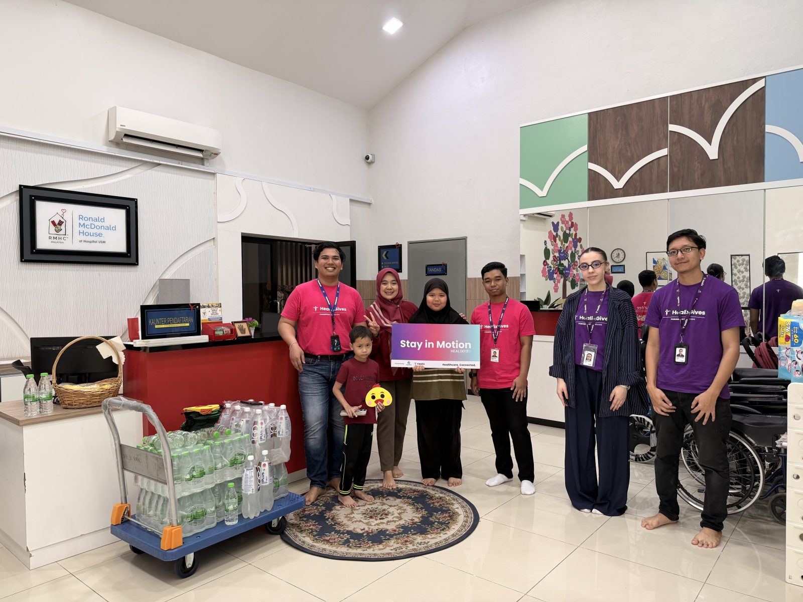The Healix team with a family at Ronald McDonald House USM Kubang Kerian